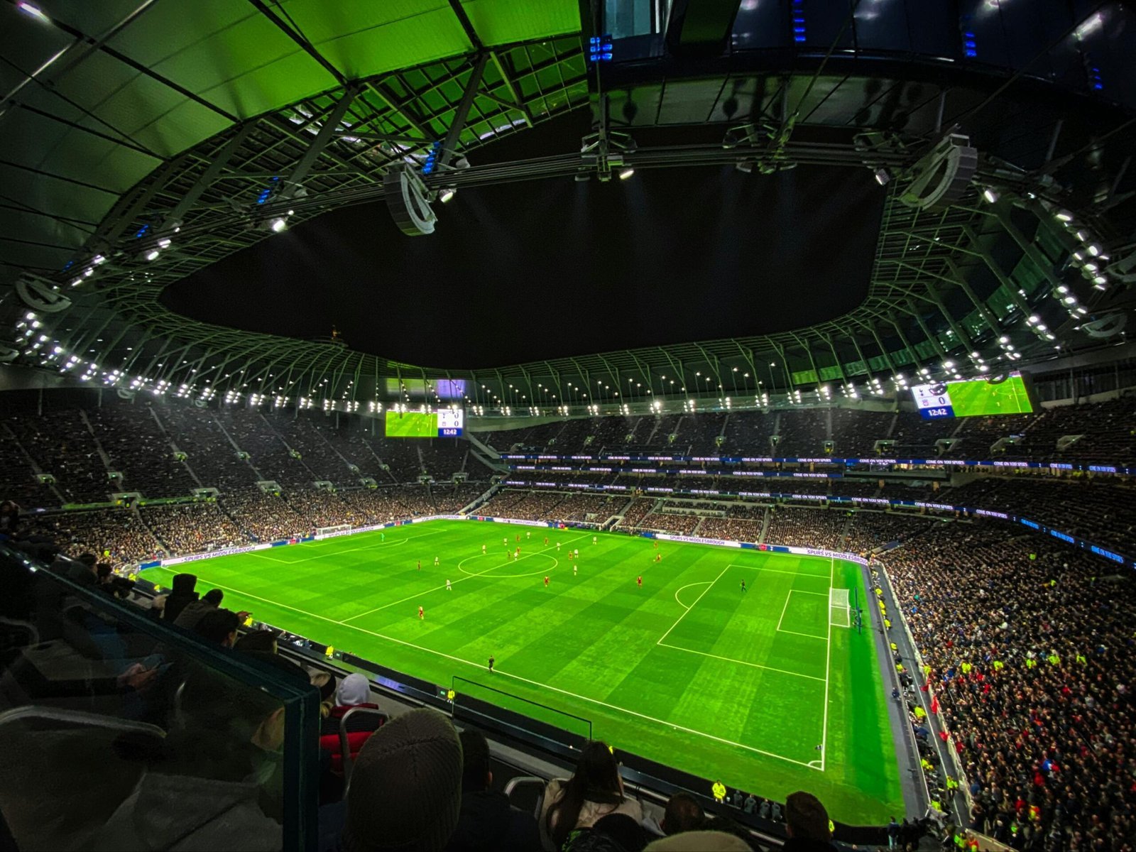 Stadium at dusk with crowd silhouettes—symbolic of governance in football